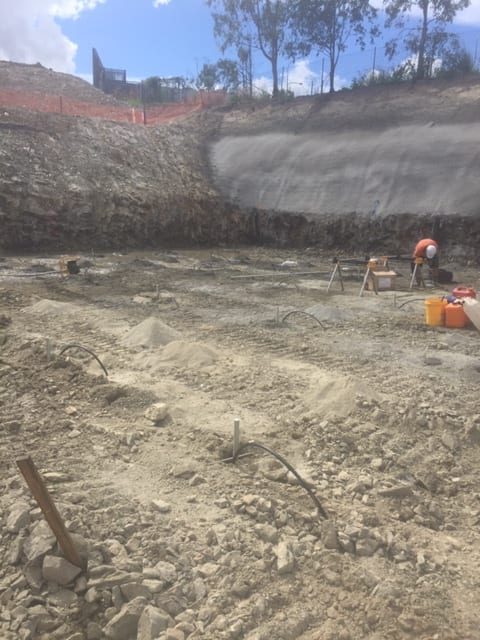One team member pumping grout by hand into the bored piers along with anchor bars to stabilise the foundation for an underground carpark